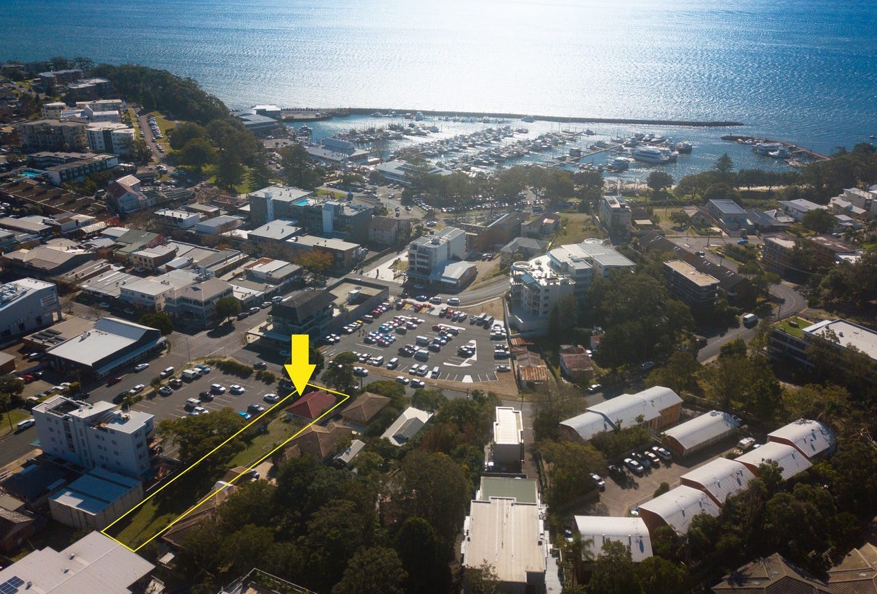 Aerial view of 33 Donald Street, Nelson Bay, with the property highlighted and the marina beyond.